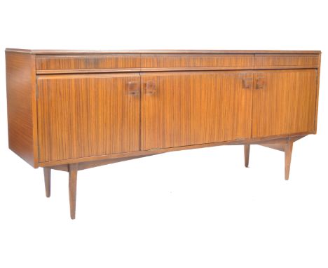 A 20th Century retro vintage Danish influenced teak wood sideboard credenza display board in the manner of Koford Larson. The