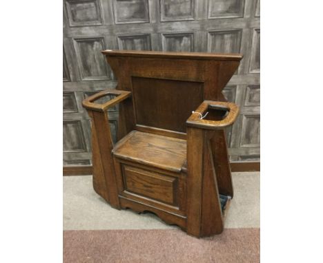 EARLY 20TH CENTURY OAK HALL SETTLE, with shaped panelled back above a hinged seat flanked by two stick stands, 82cm wide