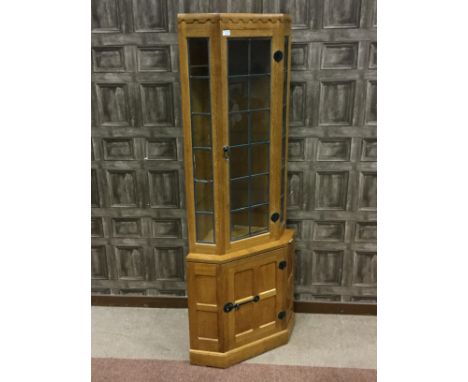 ROBERT 'MOUSEMAN' THOMPSON OAK CORNER DISPLAY CABINET, with penny moulded cornice above a leaded glass door enclosing three g