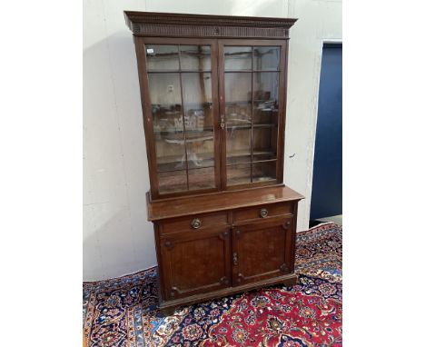 MAHOGANY CABINET BOOKCASE, the moulded dentil cornice above two astragal glazed doors enclosing shelving, the base with two m