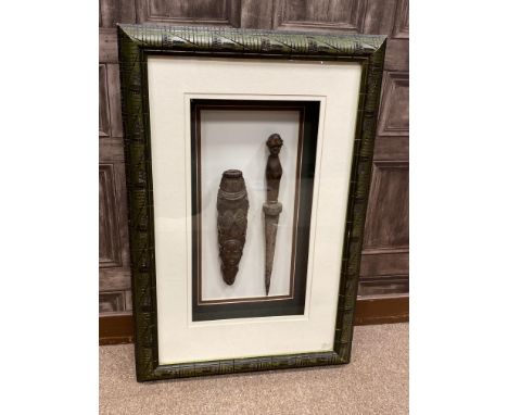 AFRICAN TRIBAL DAGGER, with carved head pommel, 39cm long, the scabbard similarly carved, mounted, framed and under glass, 78