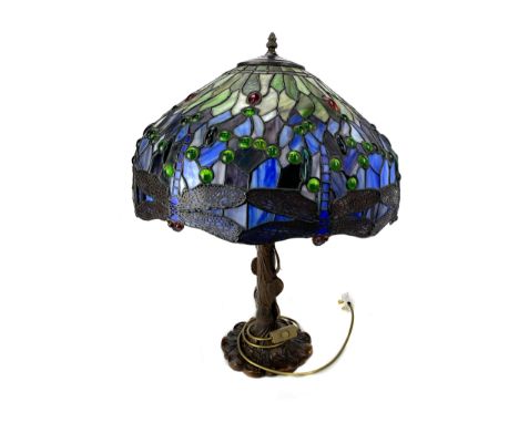 TIFFANY STYLE TABLE LAMP, the leaded glass shade decorated with a border of dragonflies, the bronzed spelter base in the form