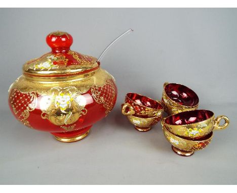 A Venetian, ruby glass punch bowl and cover with six glasses, approximately 25 cm (h) to top of punch bowl cover. [7]