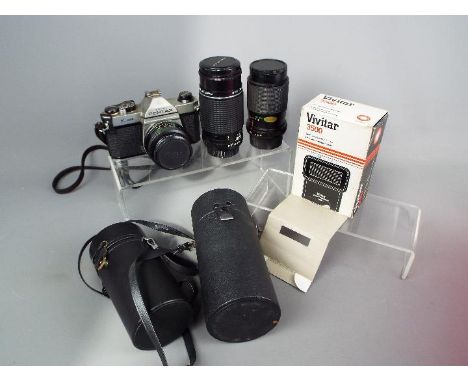 Photography - A Pentax K1000 camera with fitted Vivitar  28mm f/2.8 lens and two additional lenses comprising a Vivitar 150mm