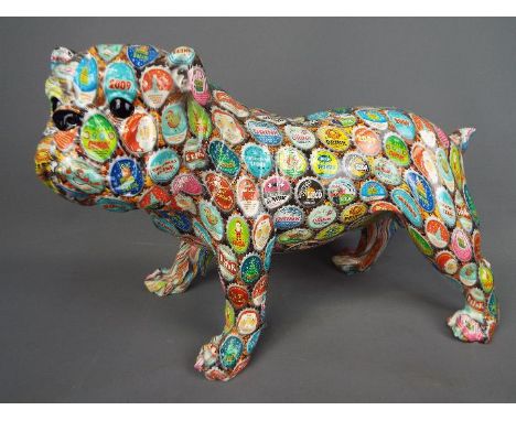 A ceramic bulldog decorated with a bottle top design, approx 27 cm (h)