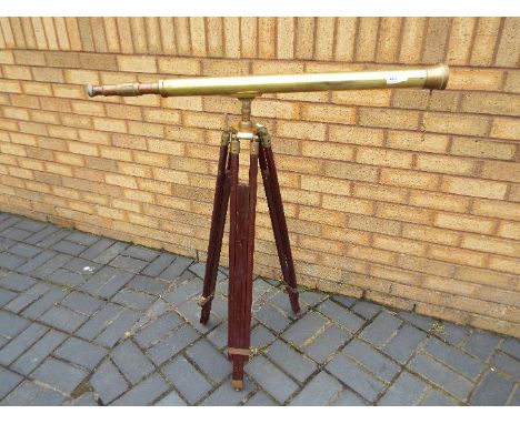 A brass telescope on wood and brass, adjustable, tripod stand, telescope approximately 98 cm (l)
