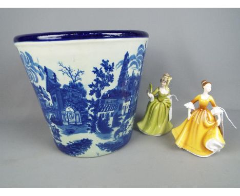 A large Victoria Ware Ironstone blue and white jardiniere or planter, approximately 29 cm (h) with two ceramic lady figurines