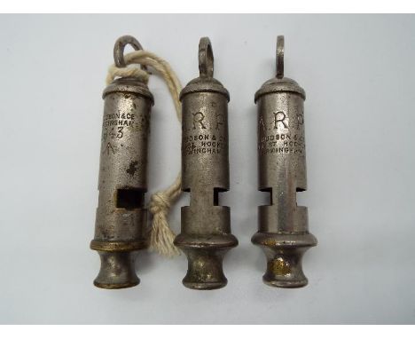 Three J. Hudson &amp; Co whistles comprising two ARP whistles and a trench whistle 1943 with broad arrow / crows foot.