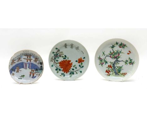 Three Chinese famille rose plates, comprising: one dish, c.1900, of lobed circular form, painted with a gate by a river, insc