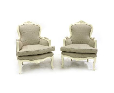 A pair of mid-19th century painted framed armchairs, in the French style, upholstered with loose cushion seats 75cm wide, 79c