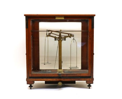 A set of G Oertling Ltd, London brass balance scales, in a glazed and mahogany case, 46cm wide, 23cm deep, 49cm highCondition