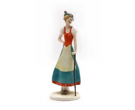 A Goebel figure of a fräulein, modelled wearing walking boots, a long skirt and with a wood stick, impressed marks and HA, 36