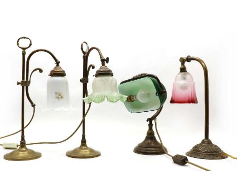 An Edwardian student's lamp, the cranberry glass adjustable shade on brass column and embossed circular base of Art Nouveau i