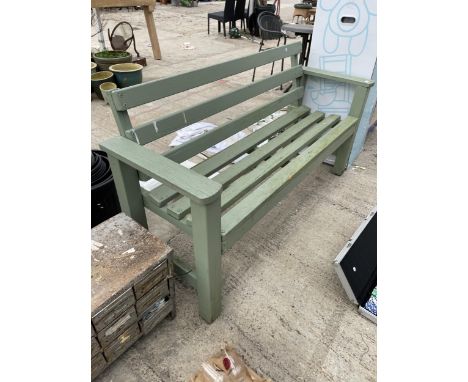 A WOODEN SLATTED THREE SEATER GARDEN BENCH