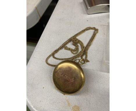 A VINTAGE BRASS COMPASS ON A CHAIN