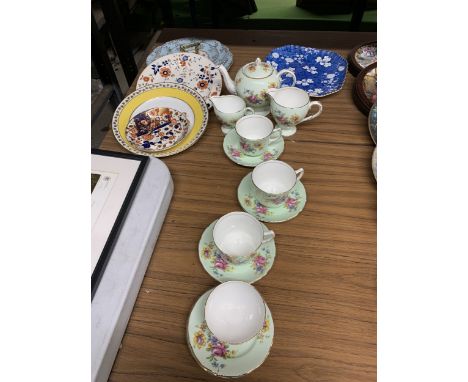 A VINTAGE PALE GREEN WITH FLORAL PATTERN TEASET TO INCLUDE A TEAPOT, CREAM JUGS, SUGAR BOWL, CUPS AND SAUCERS PLUS A QUANTITY