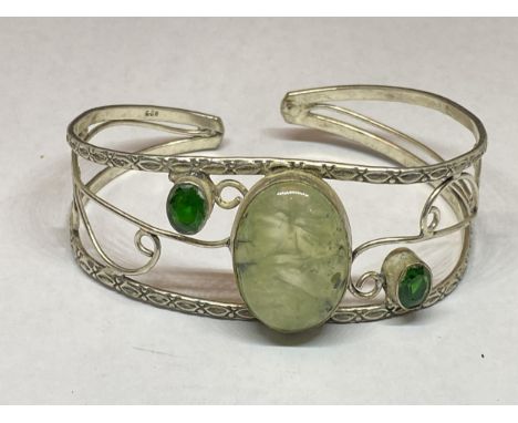 A MARKED SILVER BANGLE WITH THREE STONES