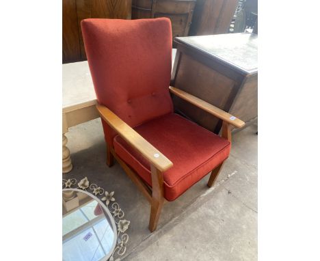 A BUTTON BACK FIRESIDE CHAIR