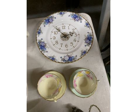 A ROYAL ALBERT 'MOONLIGHT ROSE' CERAMIC WALL CLOCK PLUS TWO VINTAGE PARAGON 'SMILING JUNE' CUPS AND SAUCERS