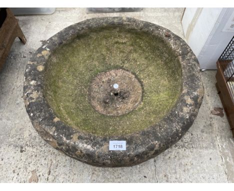 A CIRCULAR CONCRETE GARDEN PLANTER