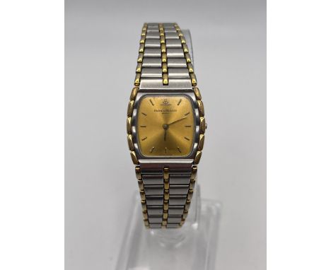 A VINTAGE BAUME AND MERCIER GENEVE GOLD AND STEEL QUARTZ WRIST WATCH