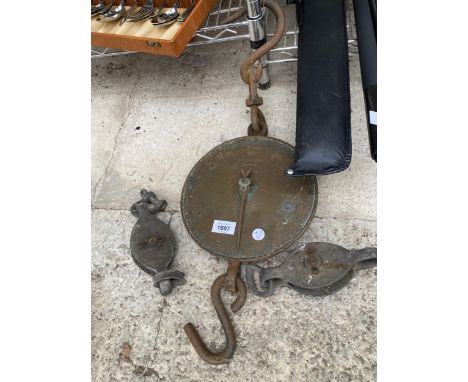 A SET OF HANGING SCALES AND TWO PULLEY WHEELS