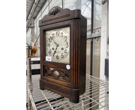 A VINTAGE OAK CASED CHIMING MANTLE CLOCK