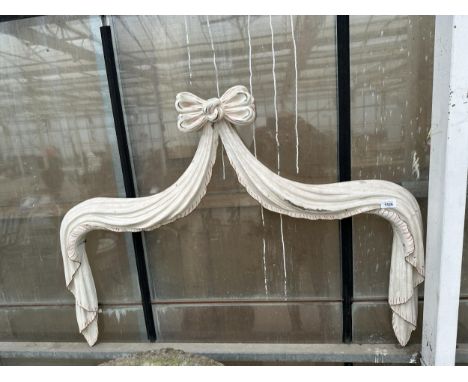 A DECORATIVE DRAPING RIBBON PELMET