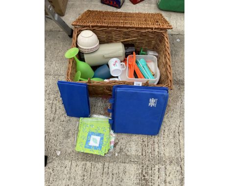 A WICKER PICNIC HAMPER BASKET WITH PICNIC ITEMS