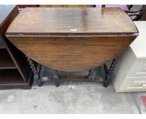 AN EARLY 20TH CENTURY OVAL OAK GATE LEG DINING TABLE ON BARLEY TWIST LEGS, 47.5" X 35" OPENED