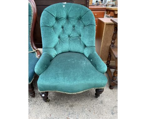 A VICTORIAN BUTTON BACK LOUNGE CHAIR ON TURNED FRONT LEGS