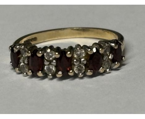 A MARKED 9 CARAT GOLD RING WITH FIVE IN LINE RUBIES SEPRATED BY DIAMONDS SIZE J/K