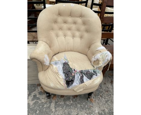 A VICTORIAN BUTTON BACK LOUNGE CHAIR ON TURNED EBONISED FRONT LEGS
