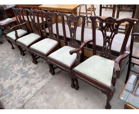 A SET OF FIVE CHIPPENDALE STYLE DINING CHAIRS, TWO BEING CARVERS ON CABRIOLE LEGS WITH BALL AND CLAW FEET