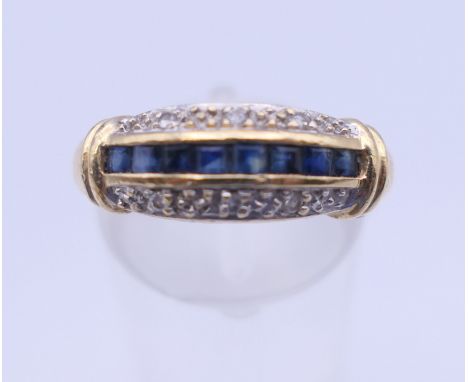 An unmarked gold diamond and sapphire ring. Ring size L/M. 3.5 grammes total weight.