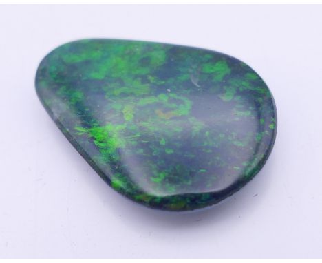 A black opal doublet.  2.25 cm long. 
