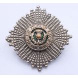 A military cap badge. 5 cm diameter.