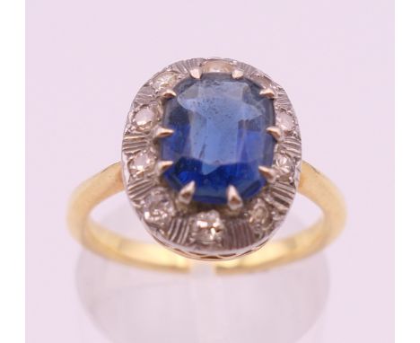 An unmarked gold, blue stone and diamond ring. Ring size M/N. 4.2 grammes total weight.