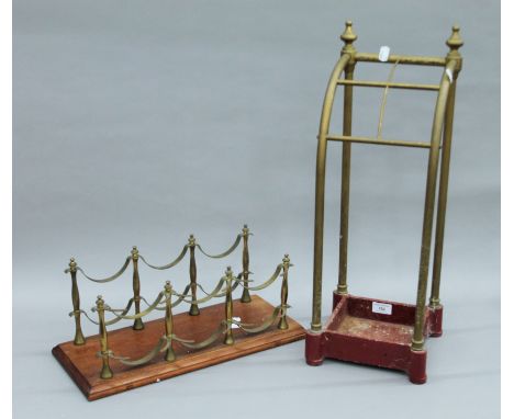 A Victorian brass and iron stick stand, and a bottle rack. The former 22 cm wide.