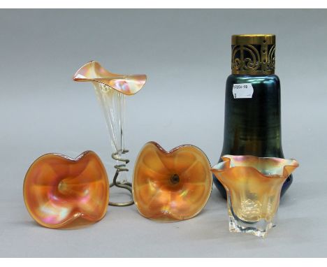 An iridescent glass vase, three epergne flutes and a vase. The former 19 cm high.