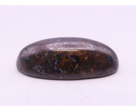 A 15.9 carat black opal. 2.5 cm long.