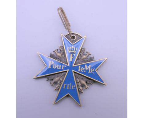 A Continental enamel decorated brass medallion.  5.5 cm high.