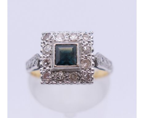 An Art Deco style 18 ct gold diamond and sapphire ring. Ring size M. 4.6 grammes total weight.