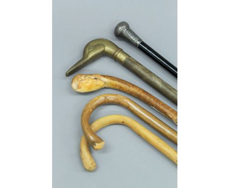 A quantity of various vintage walking sticks.