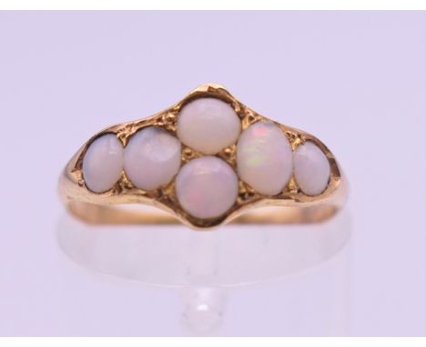 An unmarked gold opal set ring. Ring size K/L. 1.5 grammes total weight.