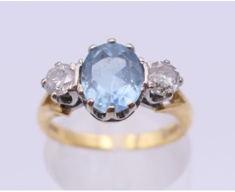 An 18 ct gold diamond and aquamarine ring. Ring size L/M. 