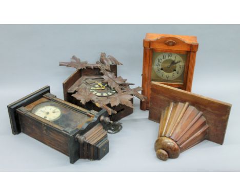 A Blackforest cuckoo clock, two wall clocks and a clock bracket. The former 47 cms high. 