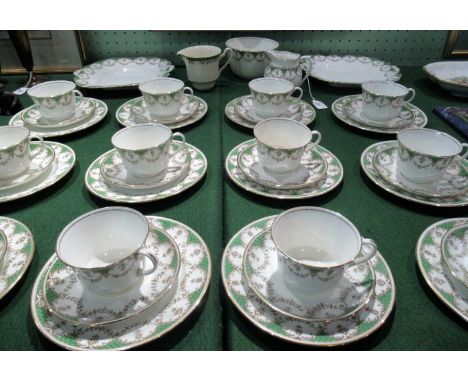 An early 20th century Ainsley tea service, comprising: twelve cups, saucers and side plates, two cake plates, slop, milk jug 