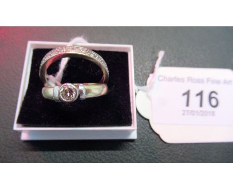 A single stone diamond ring, the brilliant cut diamond with rub-over setting to full hoop eternity ring.   Condition Report: 