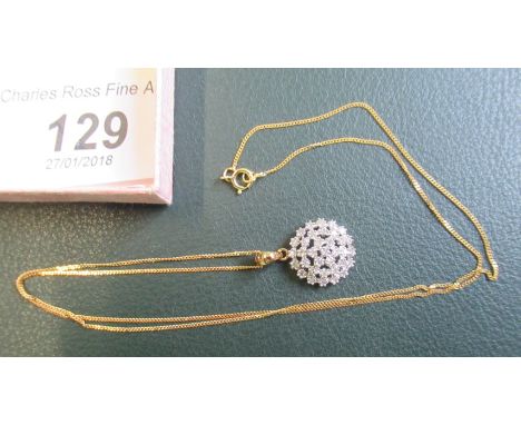 A 9ct gold and diamond openwork cluster pendant to a 9ct gold chain.